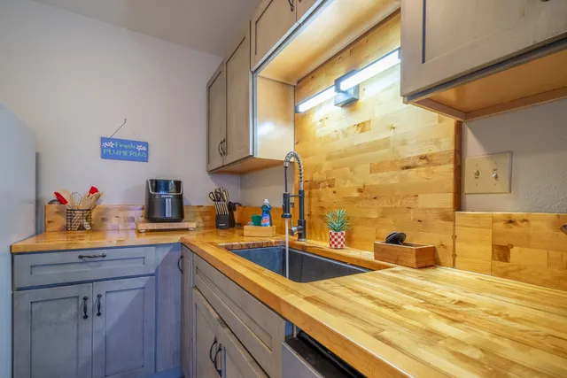 a kitchen with stainless steel appliances a sink a stove and a refrigerator