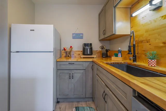 a white refrigerator freezer sitting inside of a kitchen