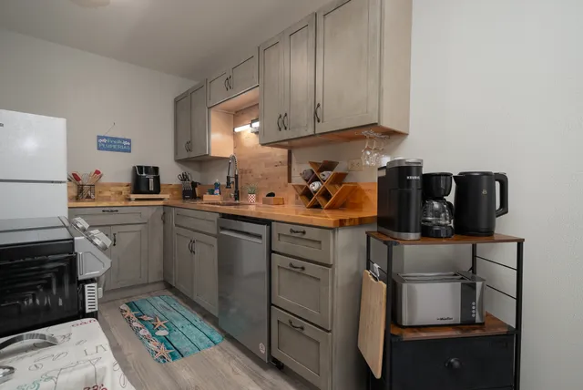 a kitchen with a sink stove and cabinets