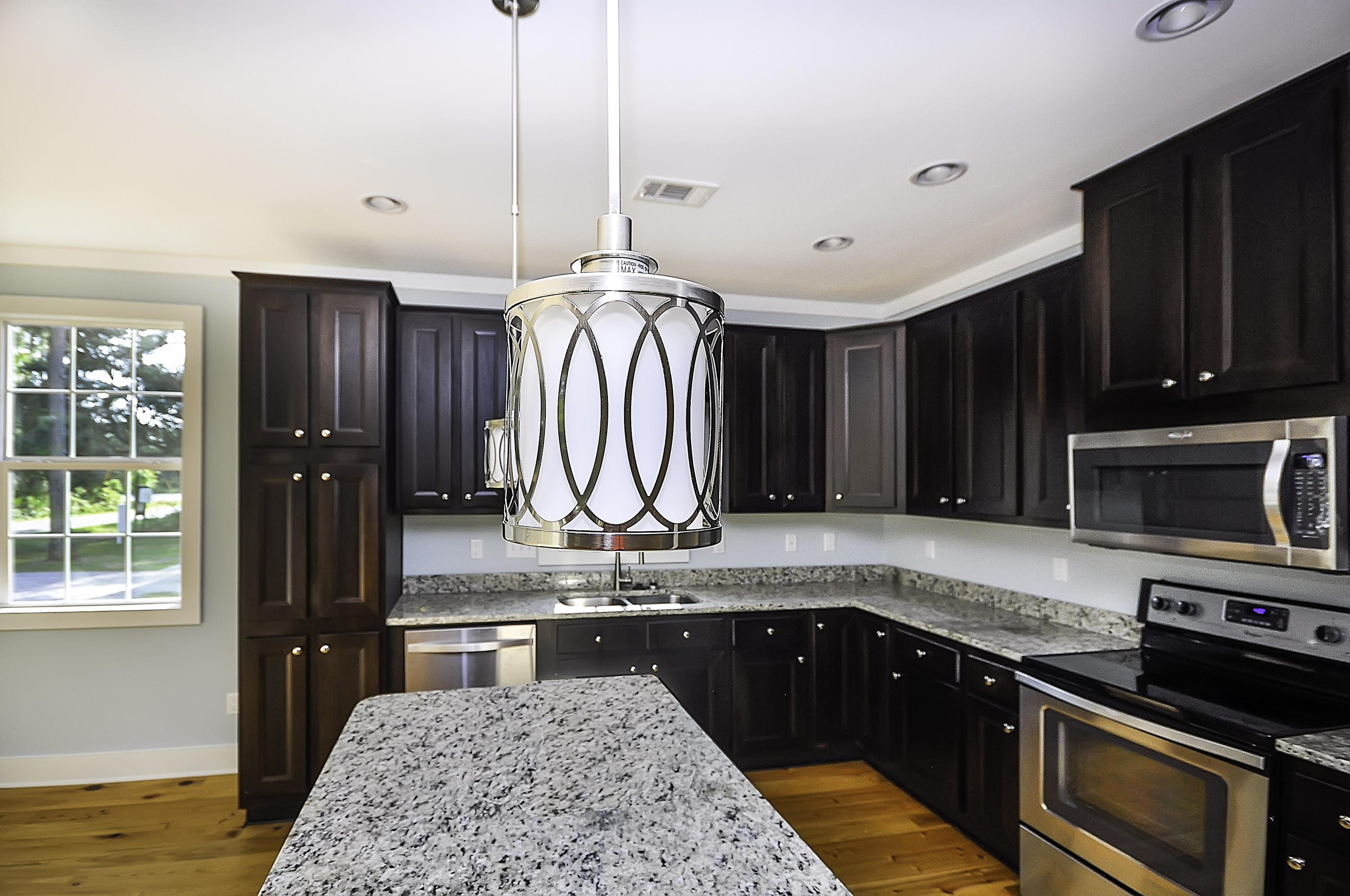 55 Sunrise Circle Santa Rosa Beach, FL 32459 - Photo 2 of 8 a kitchen with stainless steel appliances granite countertop a sink a stove and a wooden cabinets