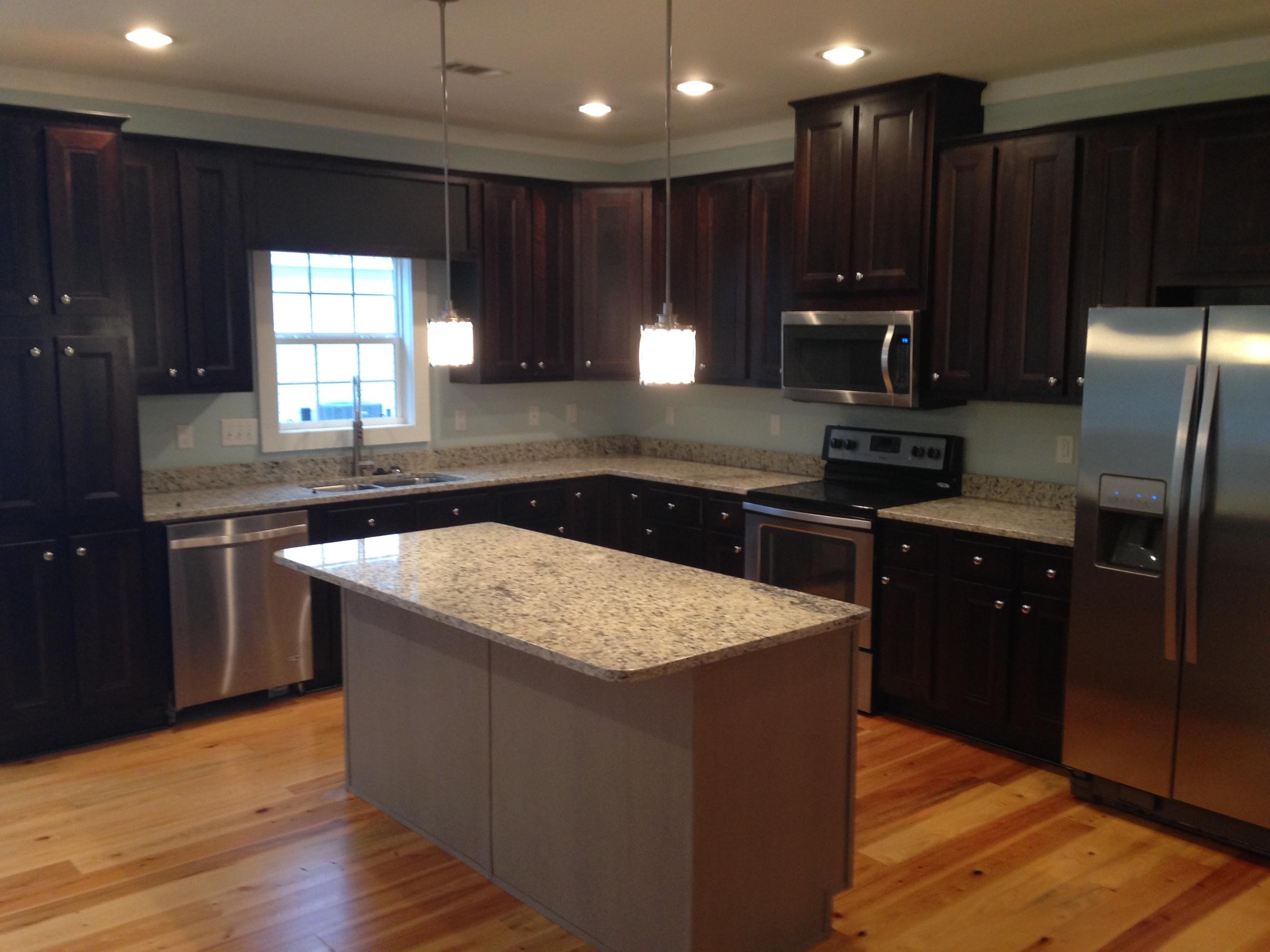 55 Sunrise Circle Santa Rosa Beach, FL 32459 - Photo 5 of 8 a kitchen with stainless steel appliances granite countertop wooden cabinets a refrigerator and a sink