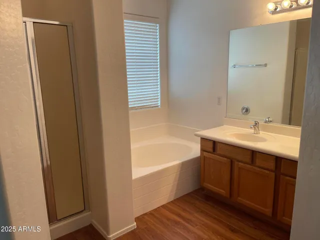 a bathroom with a tub sink and mirror