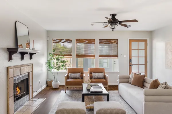 a living room with furniture fireplace and a large window