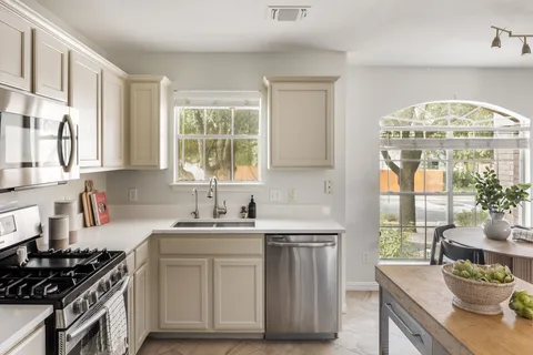 a kitchen with stainless steel appliances a refrigerator a stove a microwave and cabinets