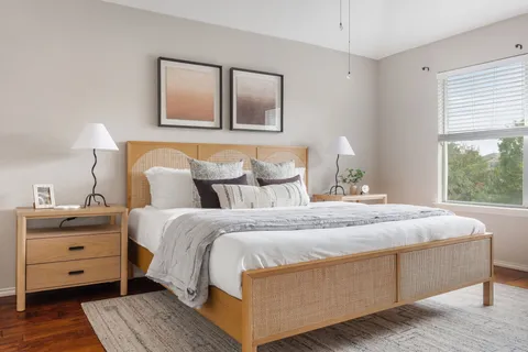 a bedroom with a bed and lamp