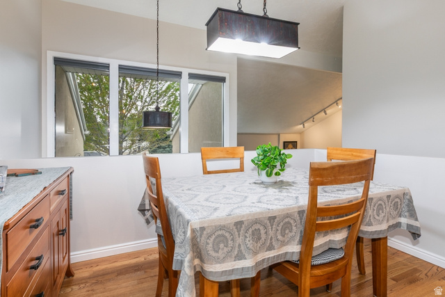10183 Hickory Point Drive Sandy, UT 84092 - Photo 7 of 36 Dining area featuring wood-finish flooring and a contemporary linear pendant light fixture
