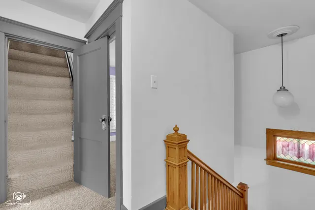a view of a house with a yard and large tree