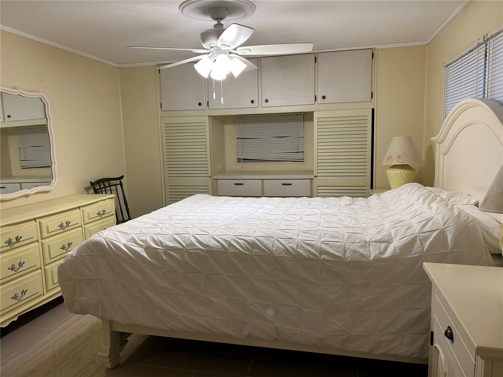 4775 Tri Par Drive Sarasota, FL 34234 - Photo 12 of 50 a bedroom with a bed and a chandelier