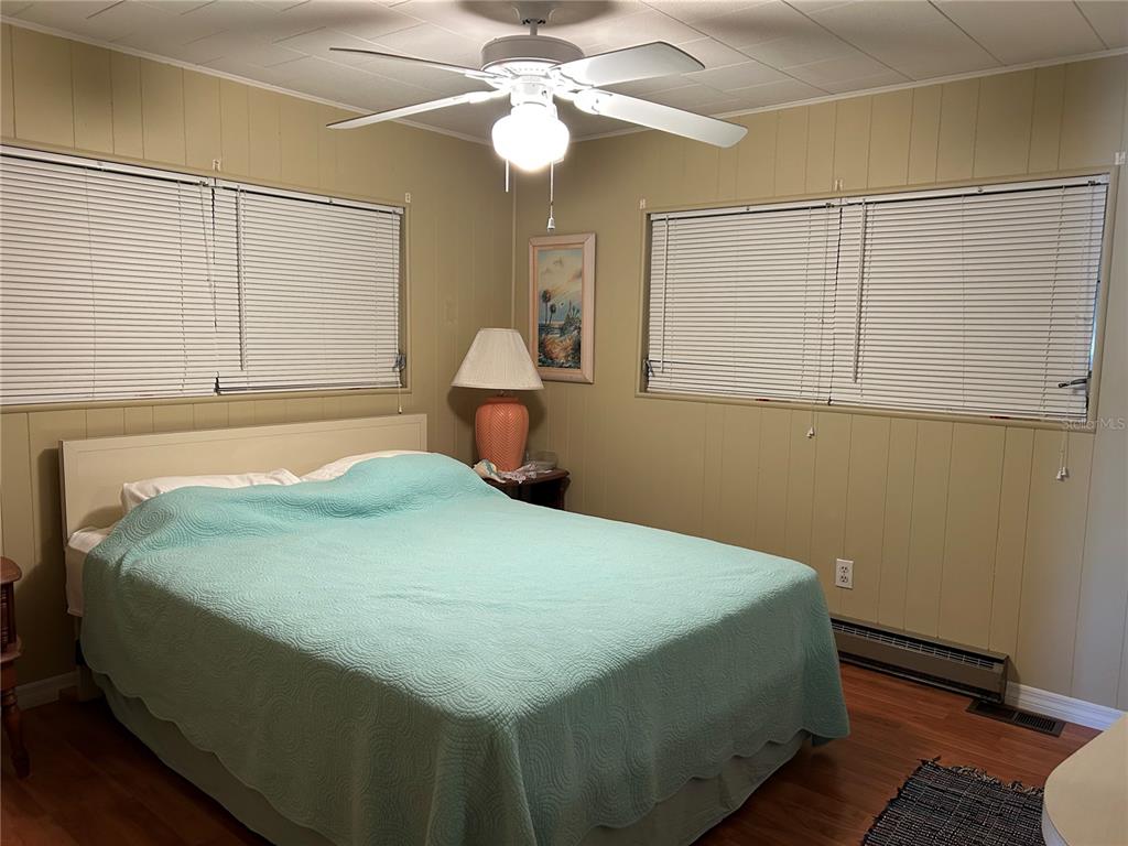 4775 Tri Par Drive Sarasota, FL 34234 - Photo 15 of 50 a bedroom with a bed and a chandelier