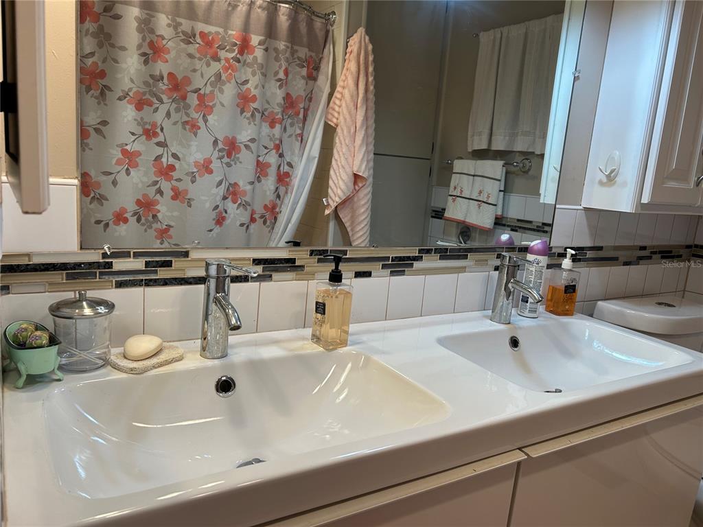 4775 Tri Par Drive Sarasota, FL 34234 - Photo 17 of 50 a bathroom with a sink and a mirror