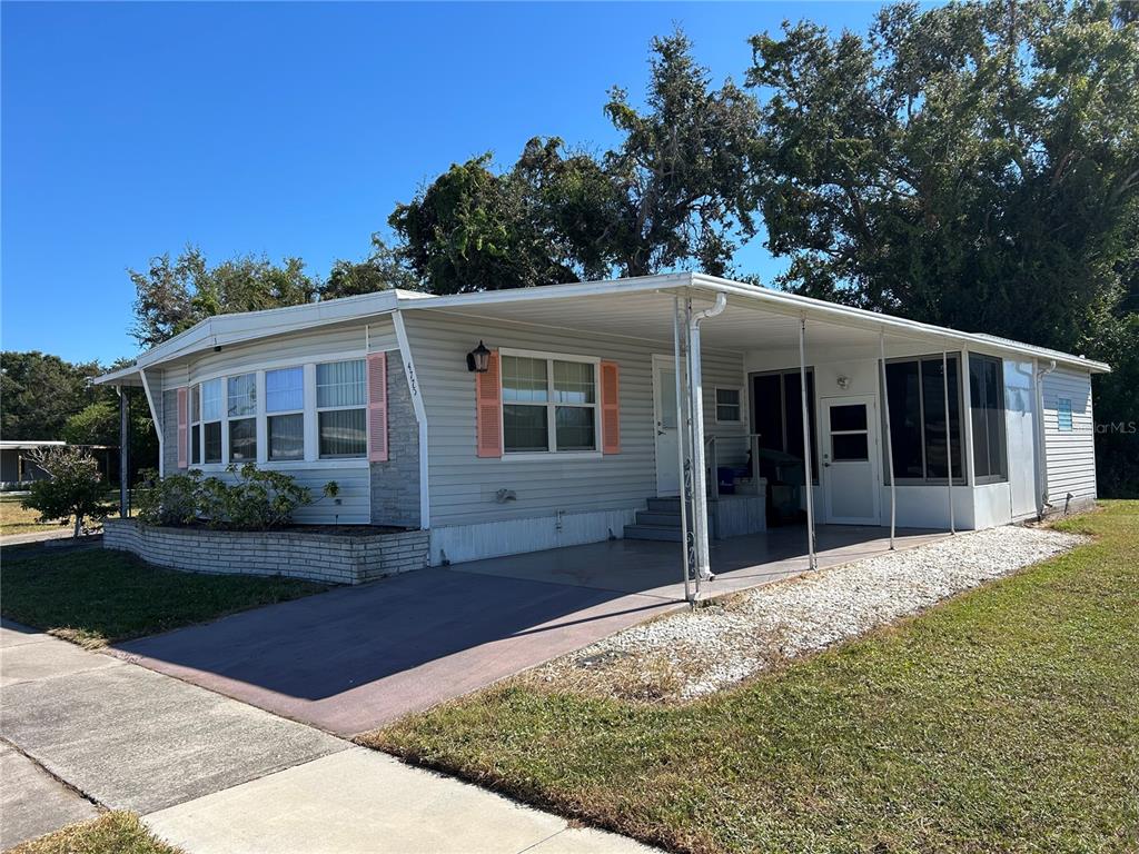 4775 Tri Par Drive Sarasota, FL 34234 - Photo 3 of 50 a front view of a house with garden