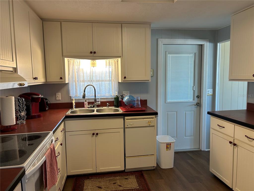 4775 Tri Par Drive Sarasota, FL 34234 - Photo 5 of 50 a kitchen with cabinets a sink and appliances