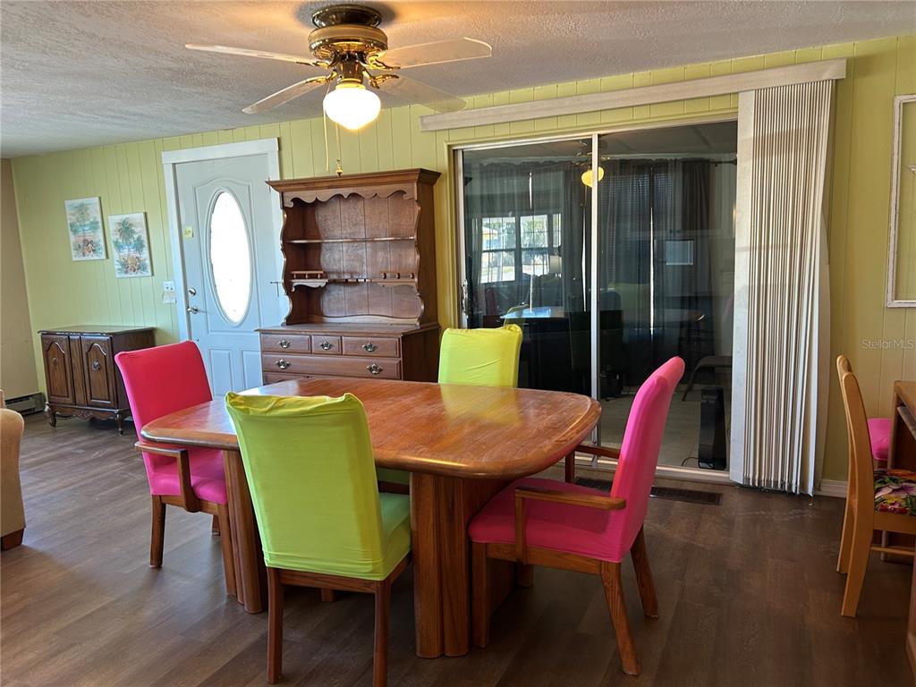 4775 Tri Par Drive Sarasota, FL 34234 - Photo 7 of 50 a view of a dining room with furniture and wooden floor