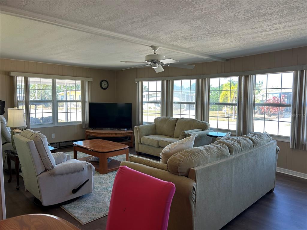 4775 Tri Par Drive Sarasota, FL 34234 - Photo 8 of 50 a living room with furniture and a flat screen tv