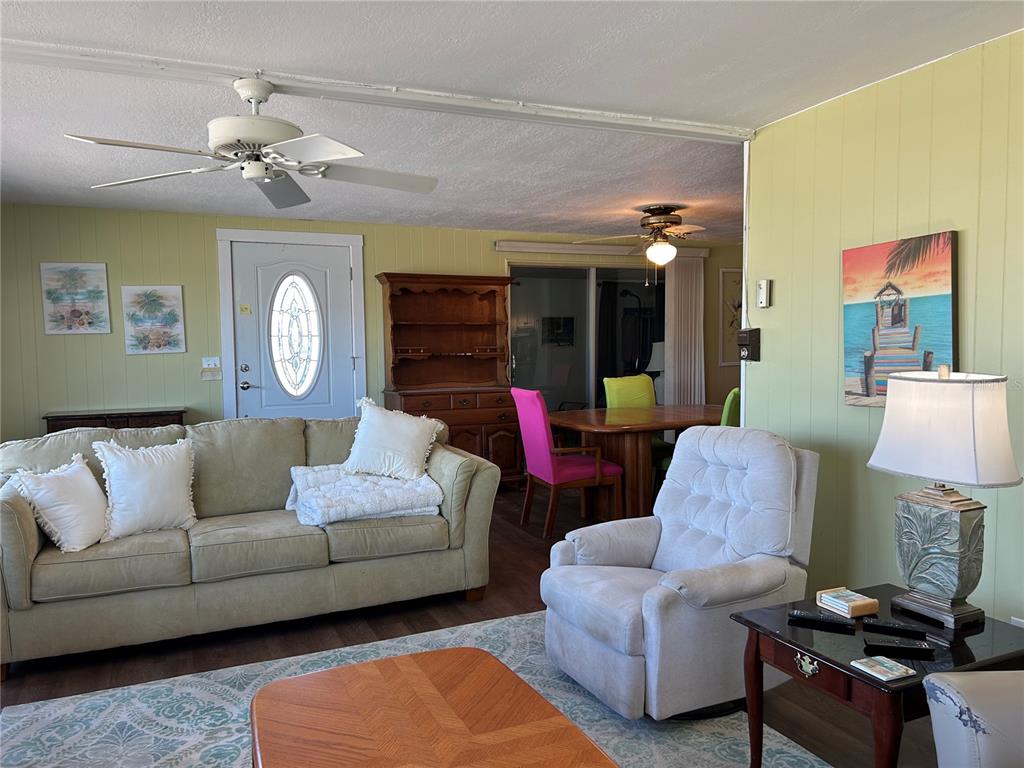 4775 Tri Par Drive Sarasota, FL 34234 - Photo 10 of 50 a living room with furniture and a chandelier