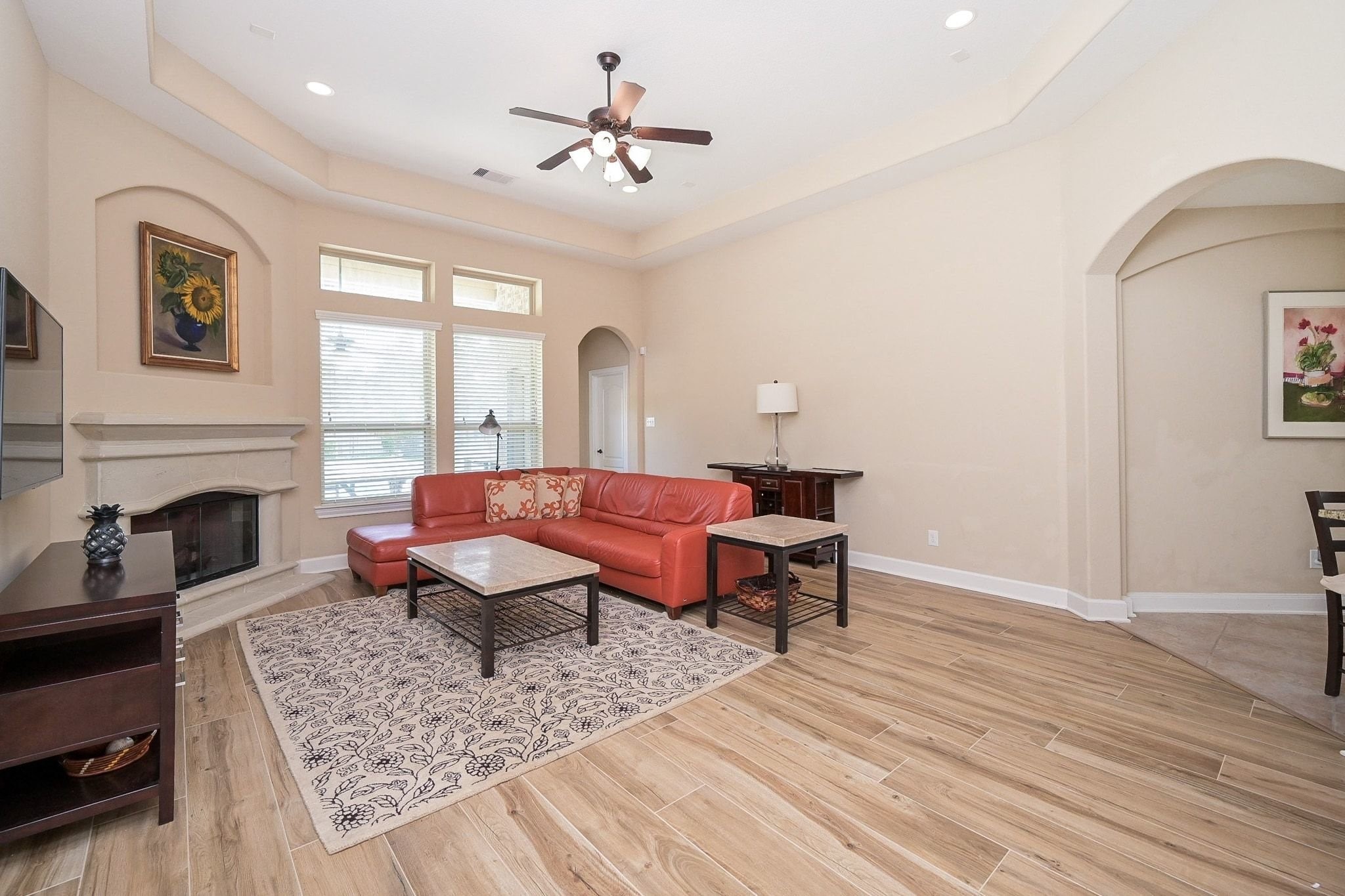 107 North Bacopa Drive Spring, TX 77389 - Photo 12 of 34 Wide view of the living room showing the seamless connection to the dining and kitchen areas through arched openings.