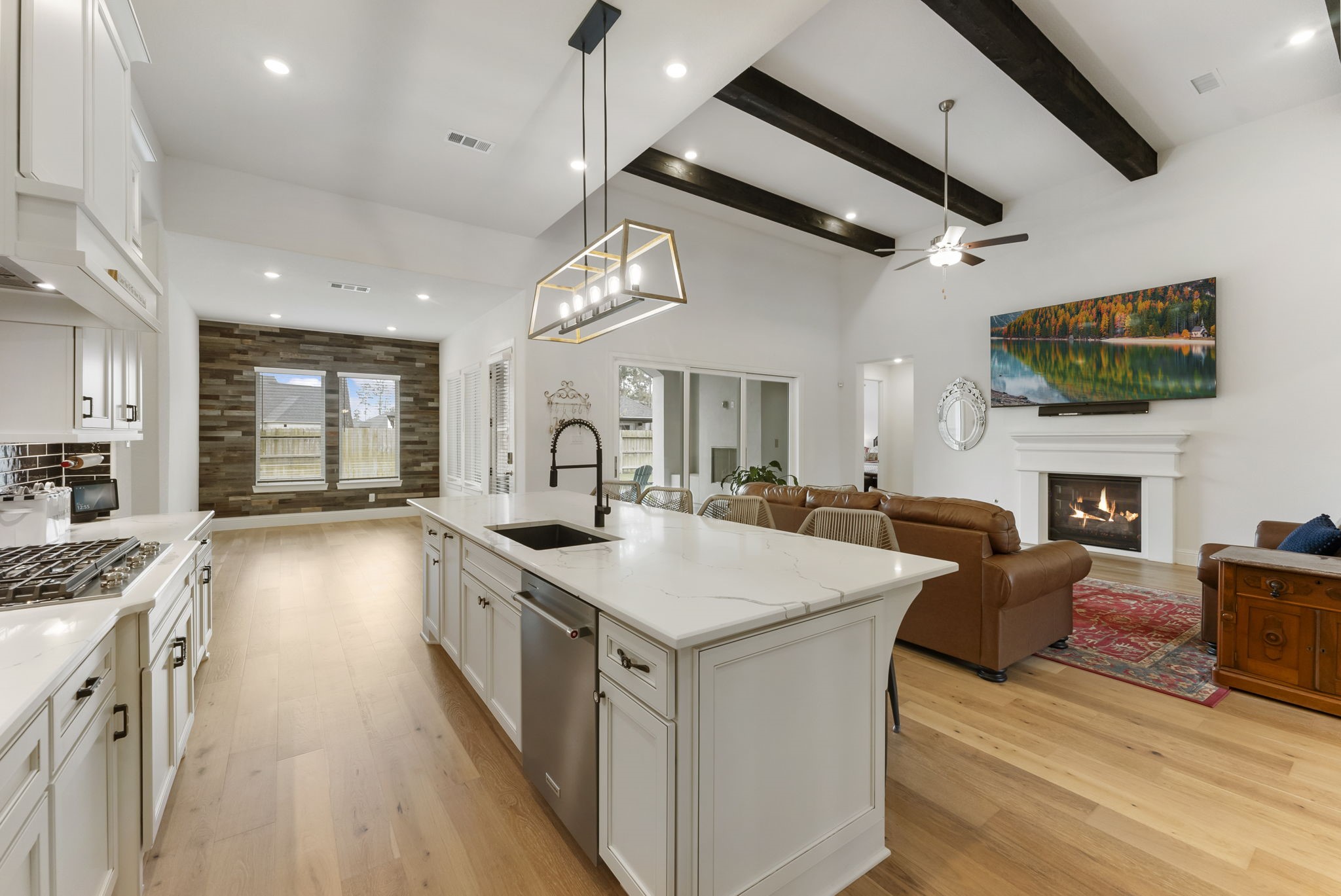 12932 Whitewater Way Conroe, TX 77302 - Photo 10 of 48 Designer lighting above the island complements the kitchen’s upscale finishes.