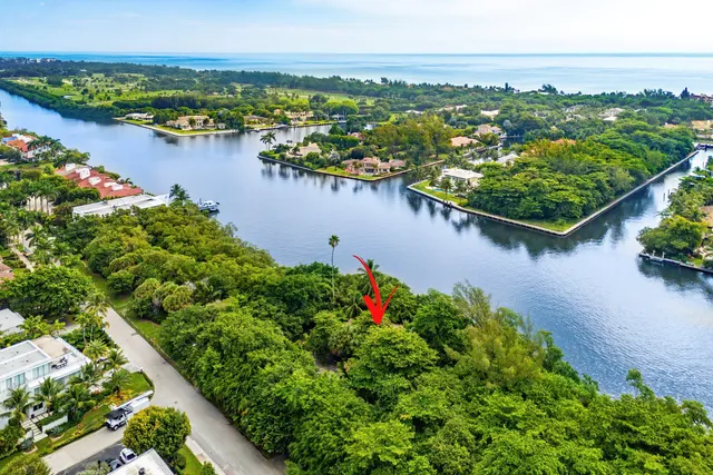 an aerial view of lake and residential houses with outdoor space