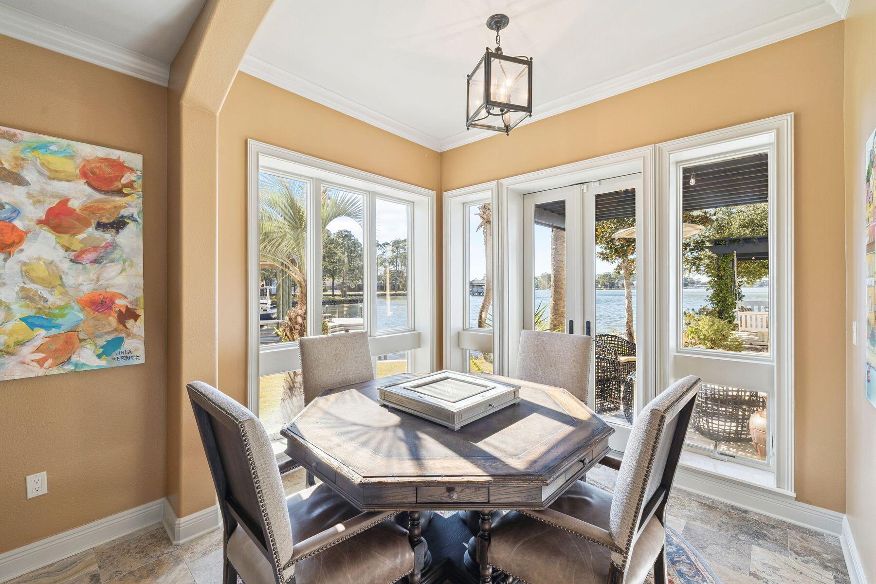 221 Bay Cir Drive Santa Rosa Beach, FL 32459 - Photo 28 of 98 a view of a dining room with furniture large windows and wooden floor