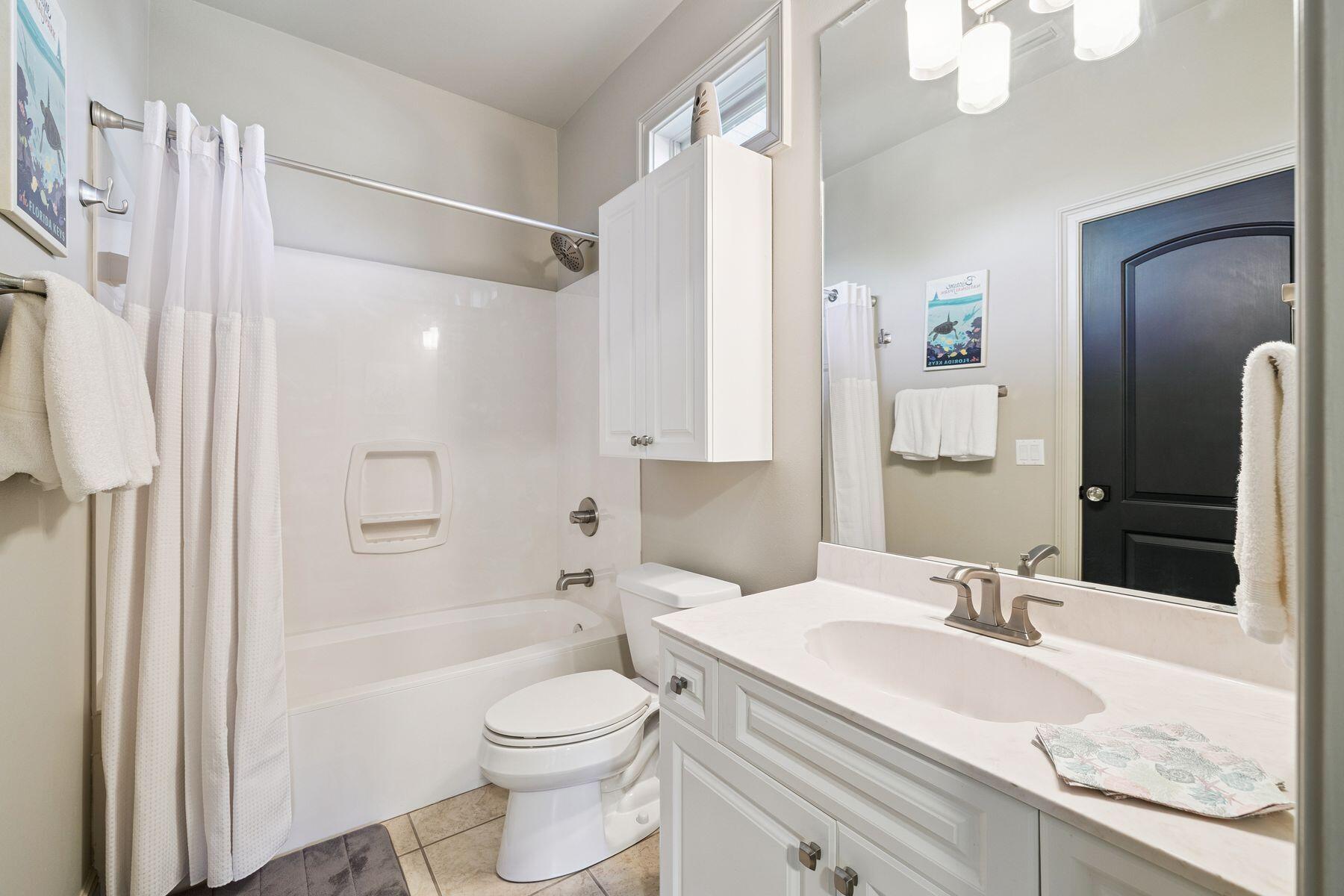 221 Bay Cir Drive Santa Rosa Beach, FL 32459 - Photo 42 of 98 a bathroom with a granite countertop sink a toilet a mirror a vanity and shower