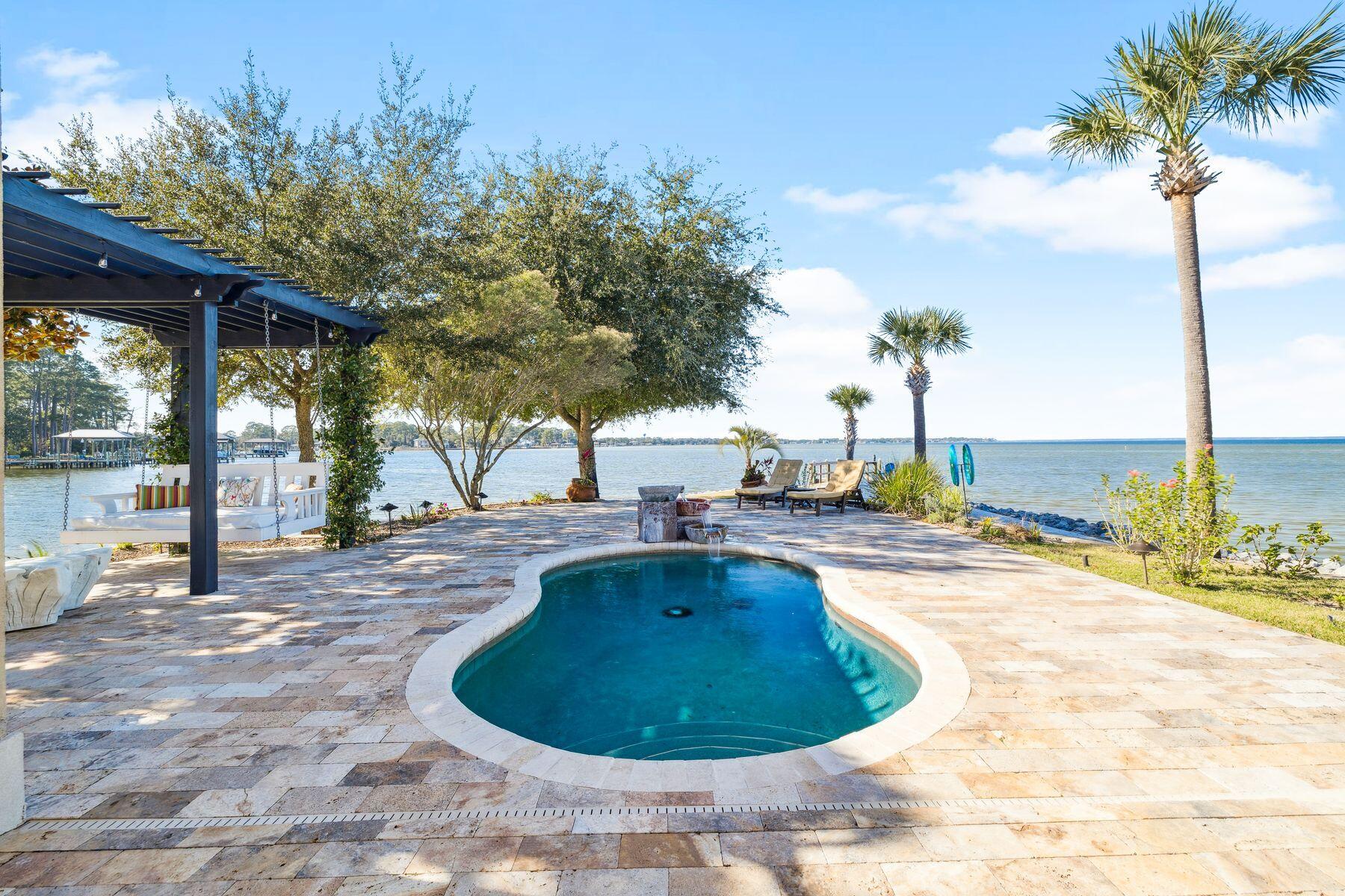 221 Bay Cir Drive Santa Rosa Beach, FL 32459 - Photo 53 of 98 a view of a swimming pool with a patio