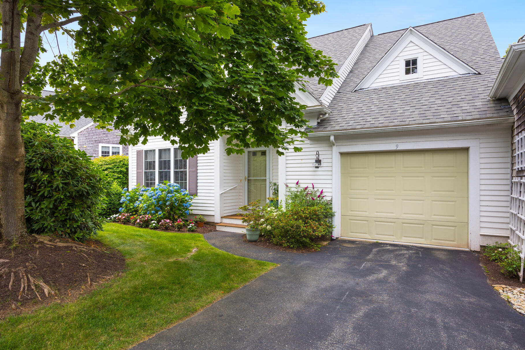 9 Stratford Ridge Mashpee, MA 02649 - Photo 1 of 34 a front view of a house with garden