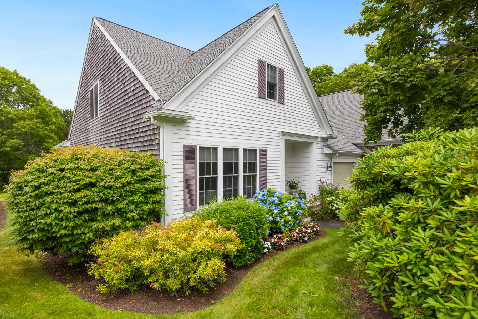 9 Stratford Ridge Mashpee, MA 02649 - Photo 2 of 34 a view of a house with potted plants and a tree