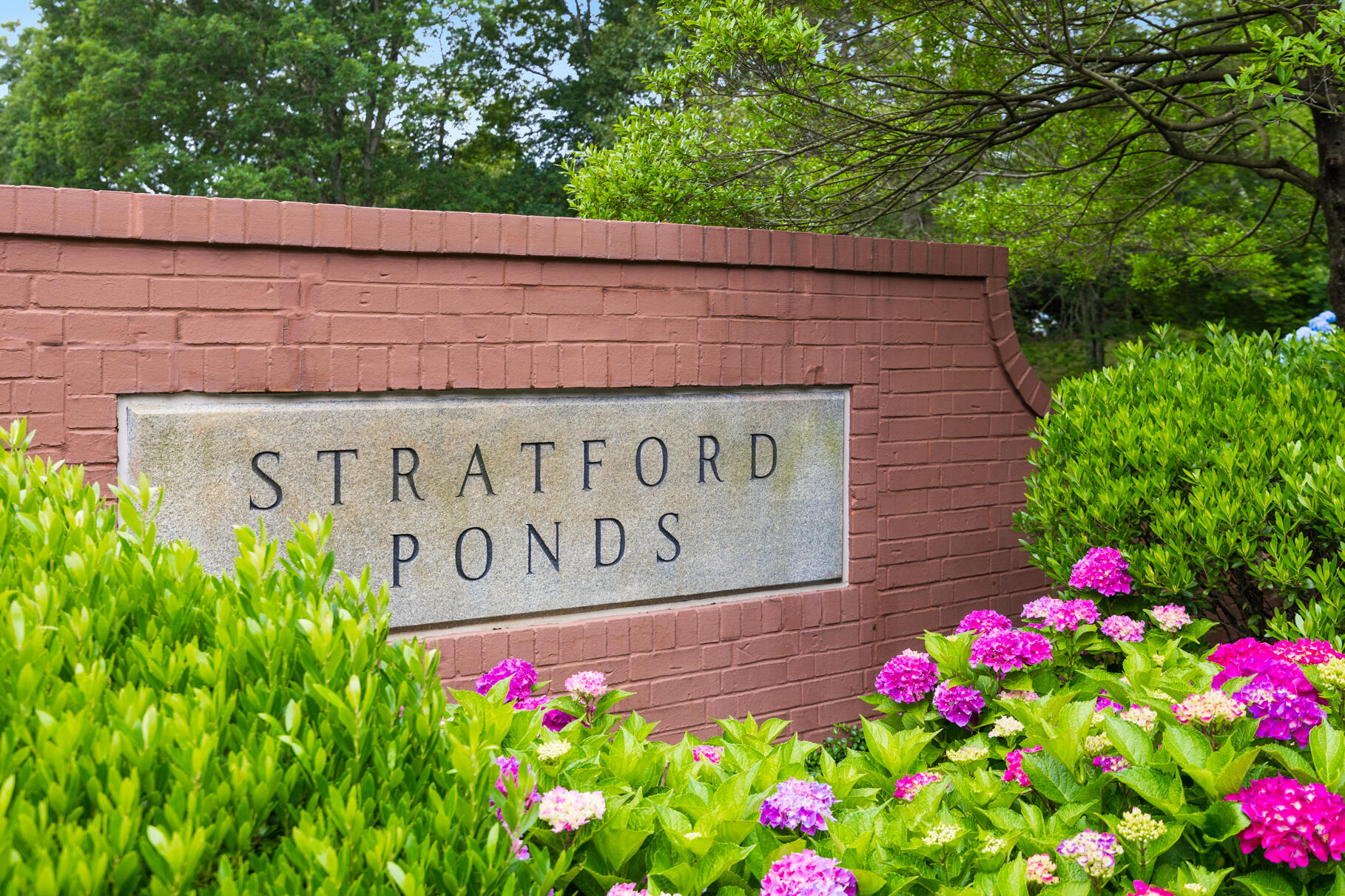 9 Stratford Ridge Mashpee, MA 02649 - Photo 34 of 34 a sign that is in front of flowers