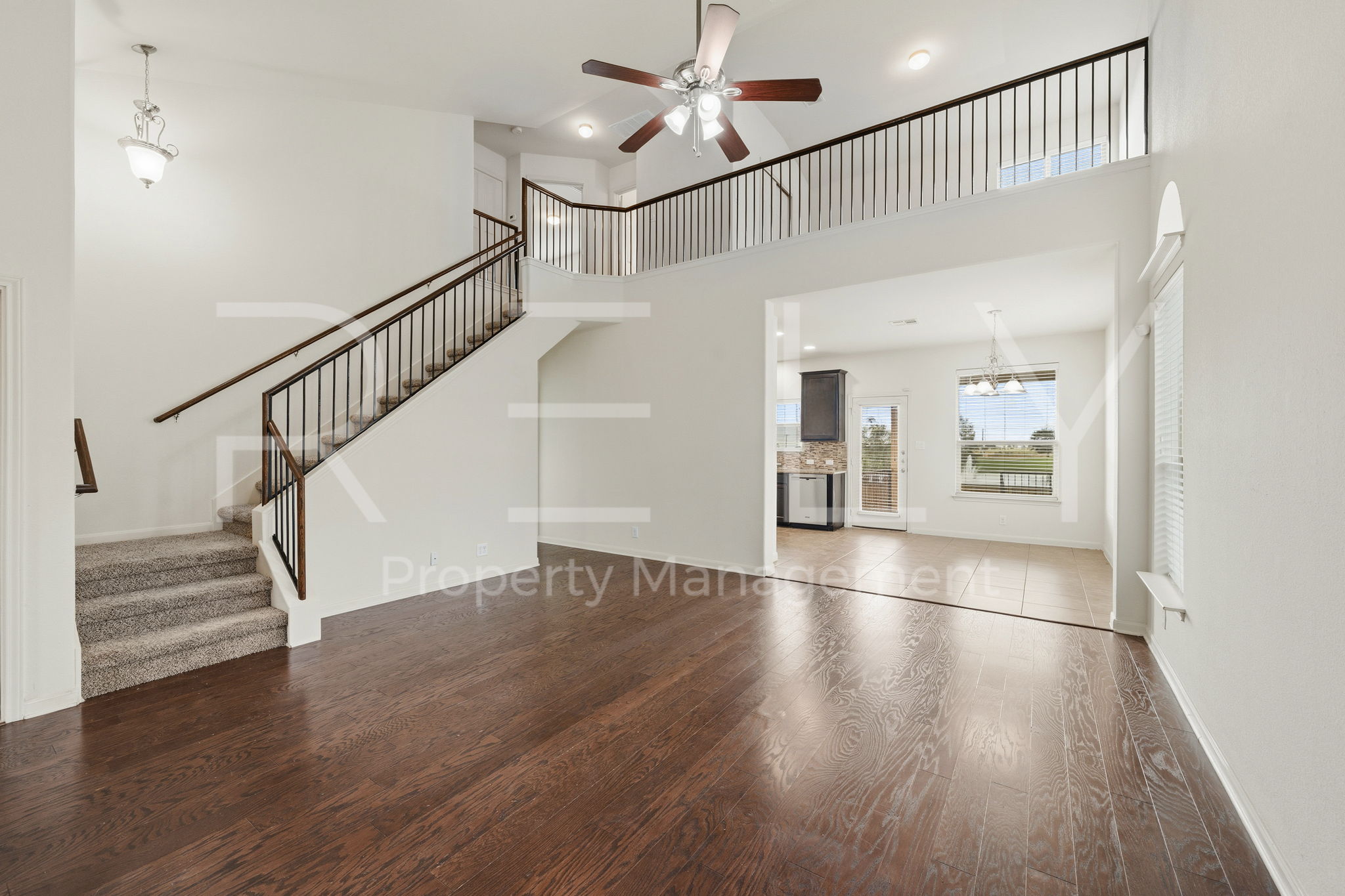 1405 Sunny Meadows Loop Georgetown, TX 78626 - Photo 4 of 40 Rich hardwood floors welcome you into this home, showcasing a sweeping staircase and an open-concept layout.