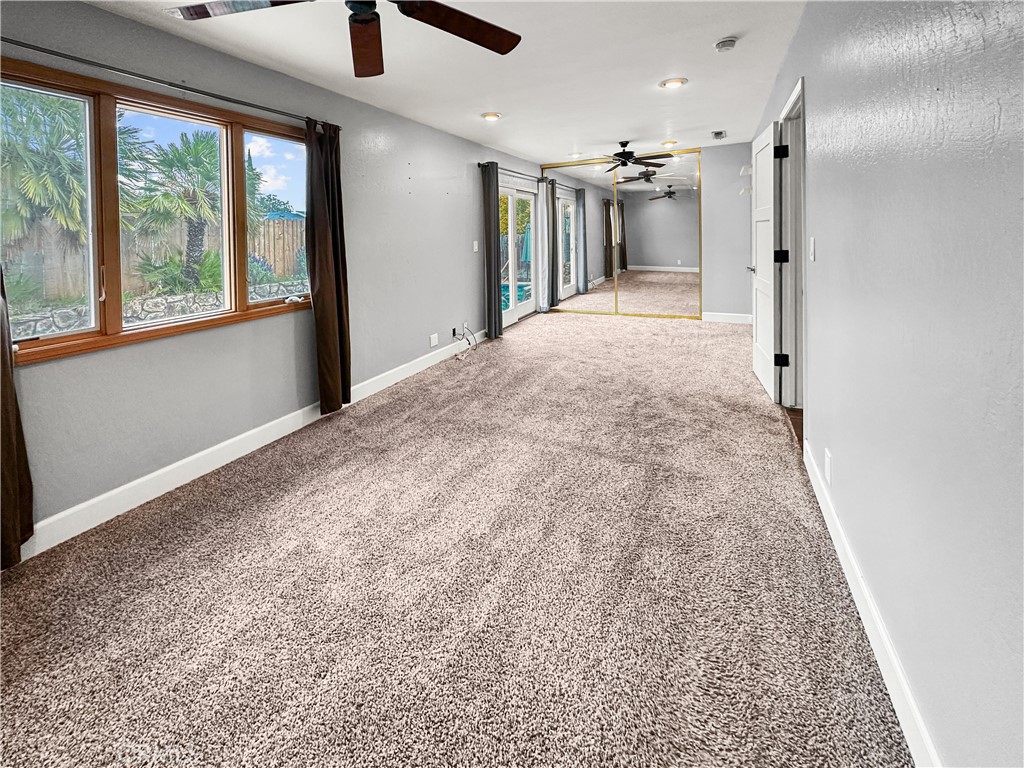15 Regent Loop Oroville, CA 95966 - Photo 9 of 22 a view of a hallway with wooden floor and a ceiling fan