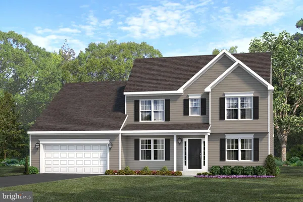 a front view of a house with a garden and yard
