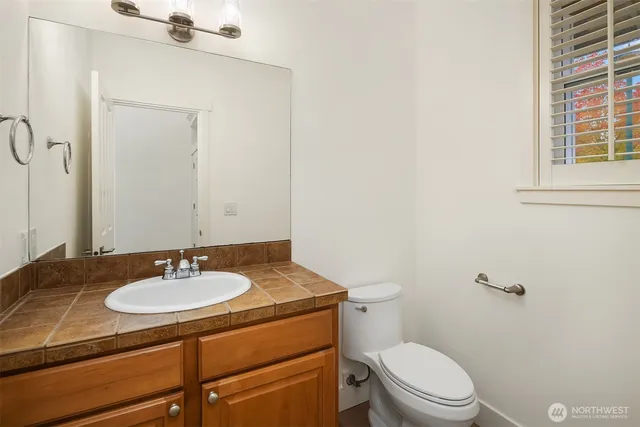 a bathroom with a sink toilet and mirror