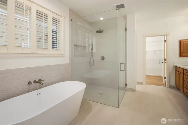 a bathroom with a bathtub and a shower