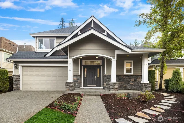 a front view of a house with a yard and garage