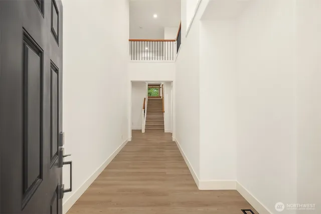 a view of a hallway with wooden floor