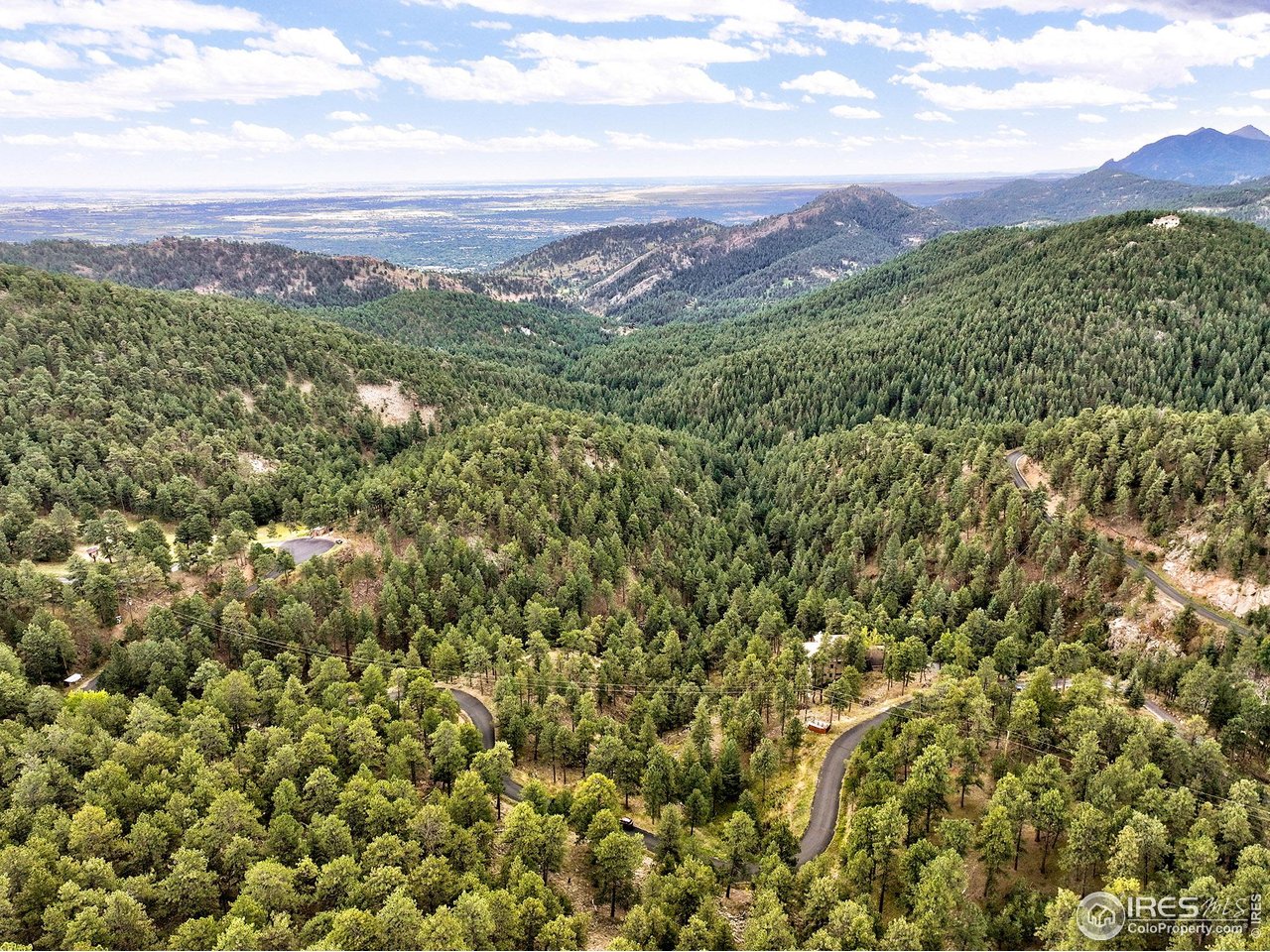 695 Cutter Lane Boulder, CO 80302 - Photo 24 of 39 a view of a city with lush green hillside