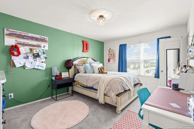 a spacious bedroom with a bed and a window