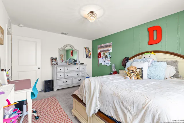 a bedroom with a bed and dresser