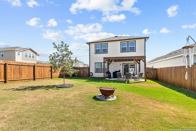 a view of a house with backyard porch and sitting area