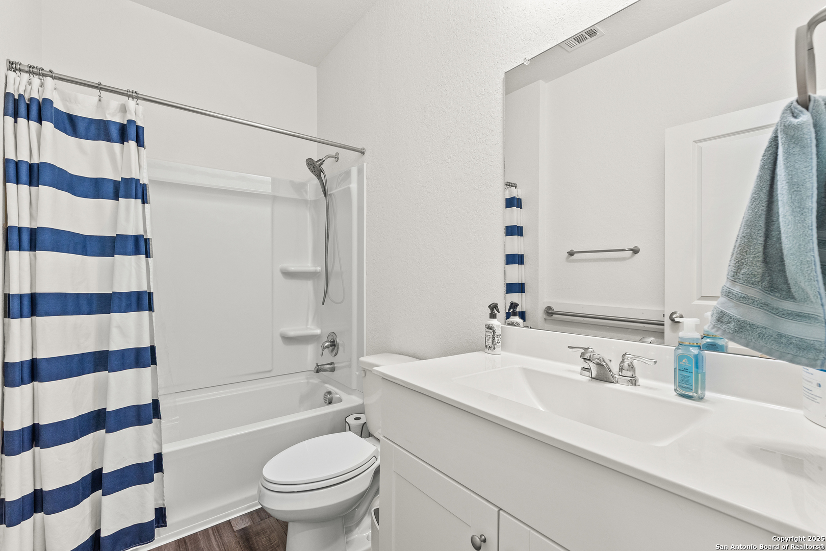 5259 Winding Streme St. Hedwig, TX 78152 - Photo 6 of 24 a bathroom with a sink a toilet a mirror and shower