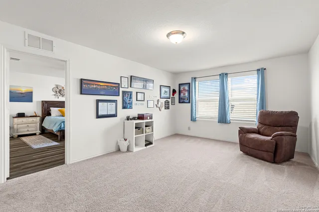 a view of a livingroom with workspace and a window