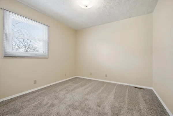 an empty room with a empty space and window