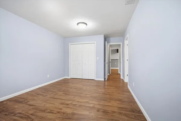 a view of a room with wooden floor