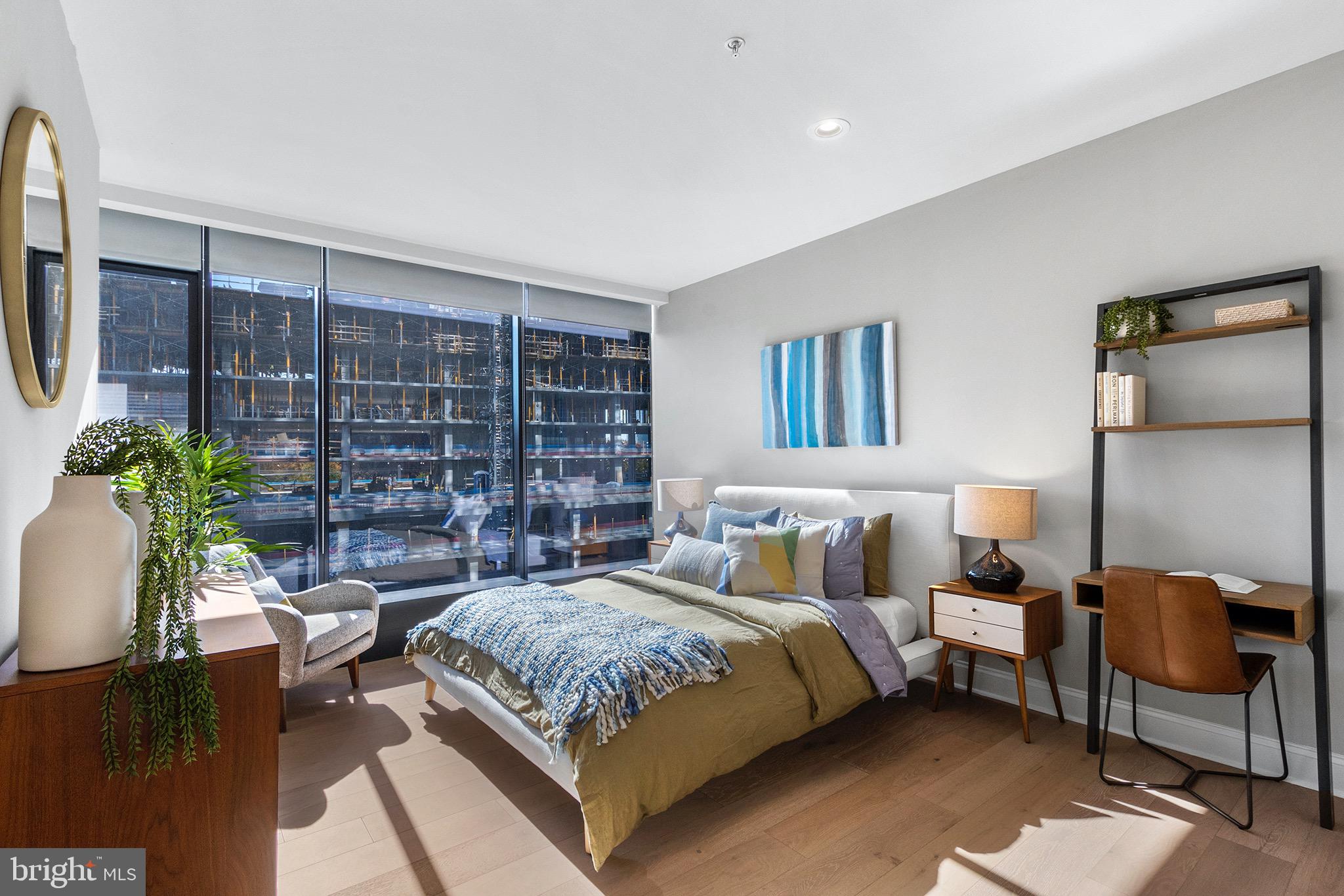 58 North 23rd Street, Unit 1309 Philadelphia, PA 19103 - Photo 10 of 30 a bedroom with a large bed and a potted plant