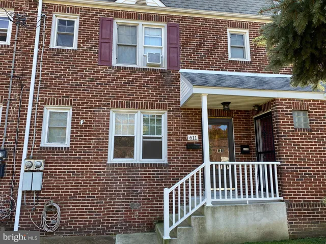 a view of a brick house with large windows