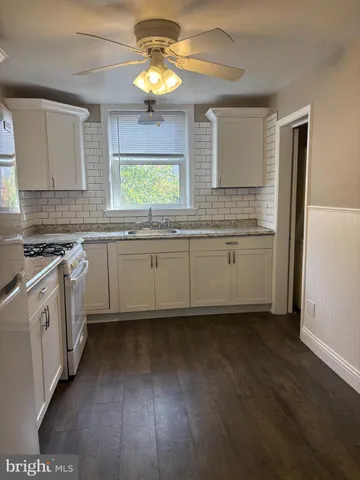 a kitchen with stainless steel appliances a stove a sink and a refrigerator