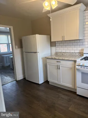 a white refrigerator freezer sitting inside of a kitchen