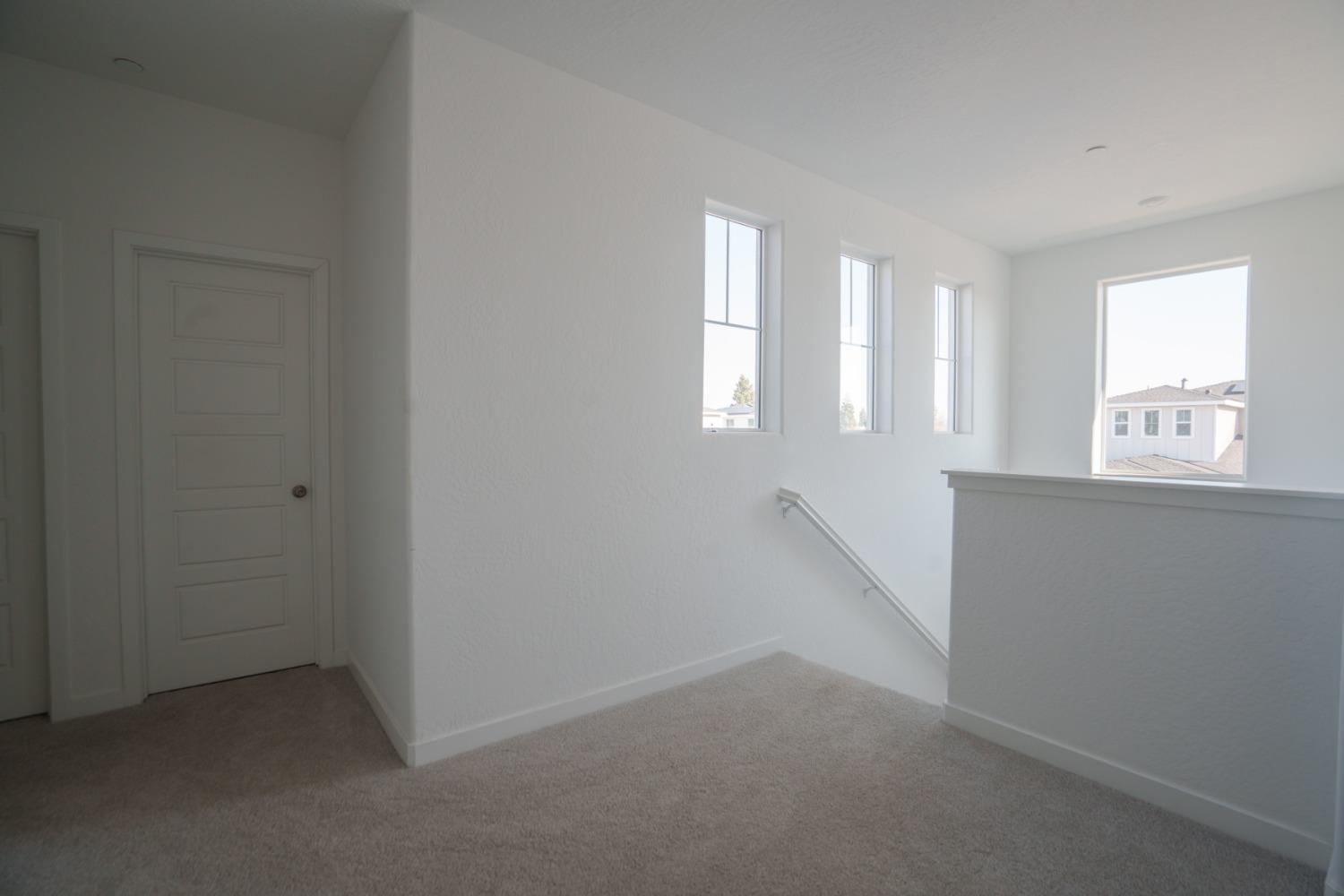 5769 West Austin Way Fresno, CA 93722 - Photo 11 of 32 an empty room with windows