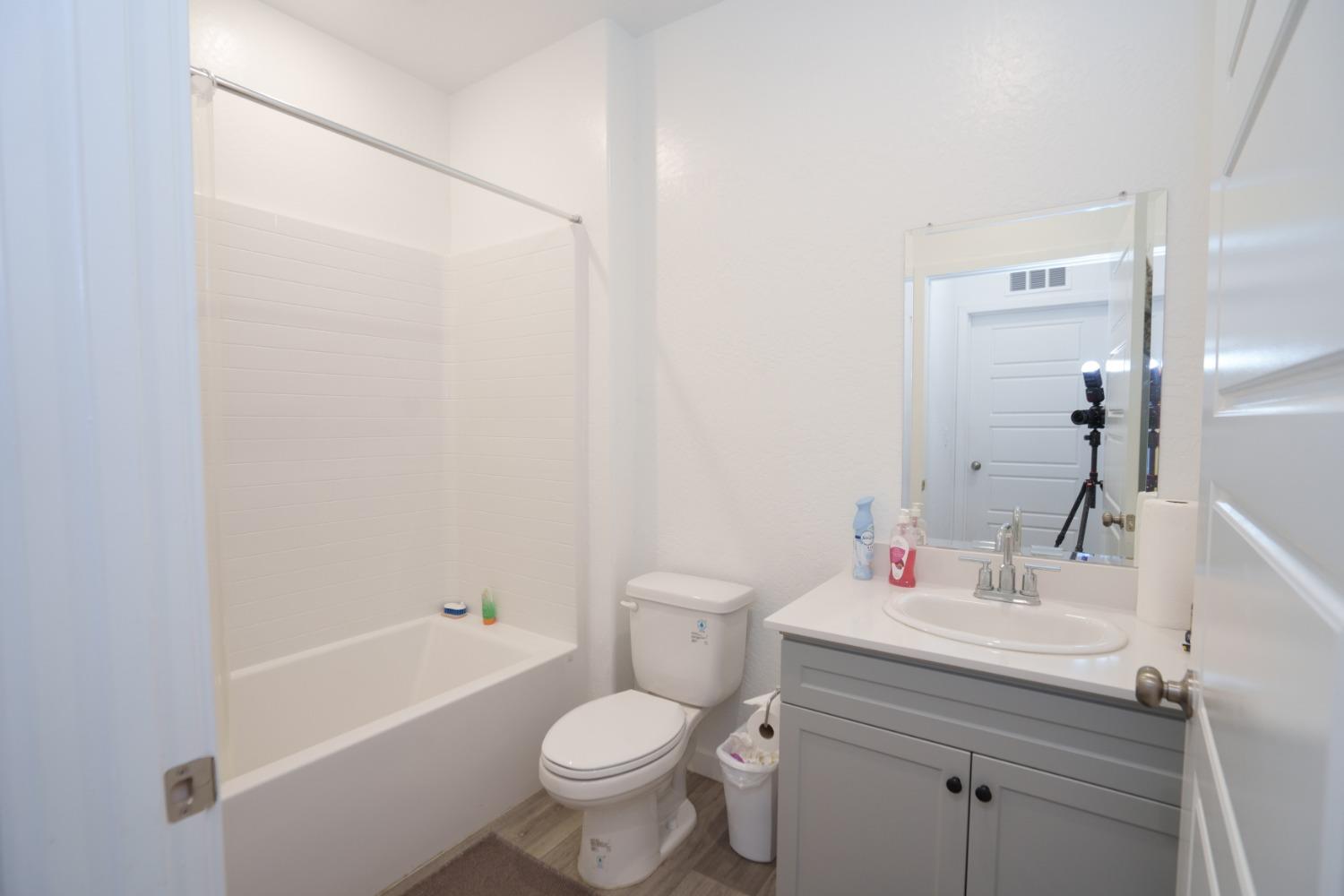 5769 West Austin Way Fresno, CA 93722 - Photo 14 of 32 a bathroom with a sink toilet and shower