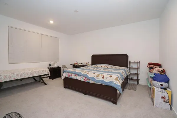 a bedroom with a bed and a couch